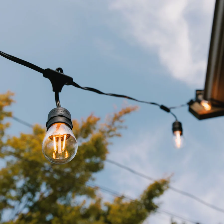 Warm Edison bulb string lights hanging over a patio