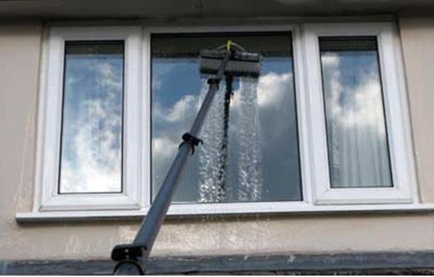 Water-fed pole washing a window